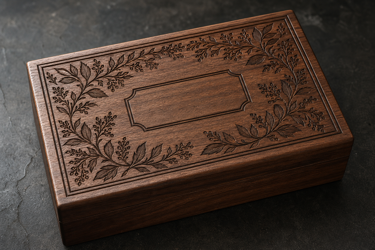 A walnut keepsake box with a detailed engraved botanical border